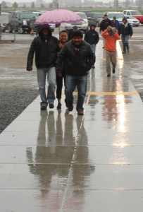 Walking in the rain to the Tulare water forum on March 26.