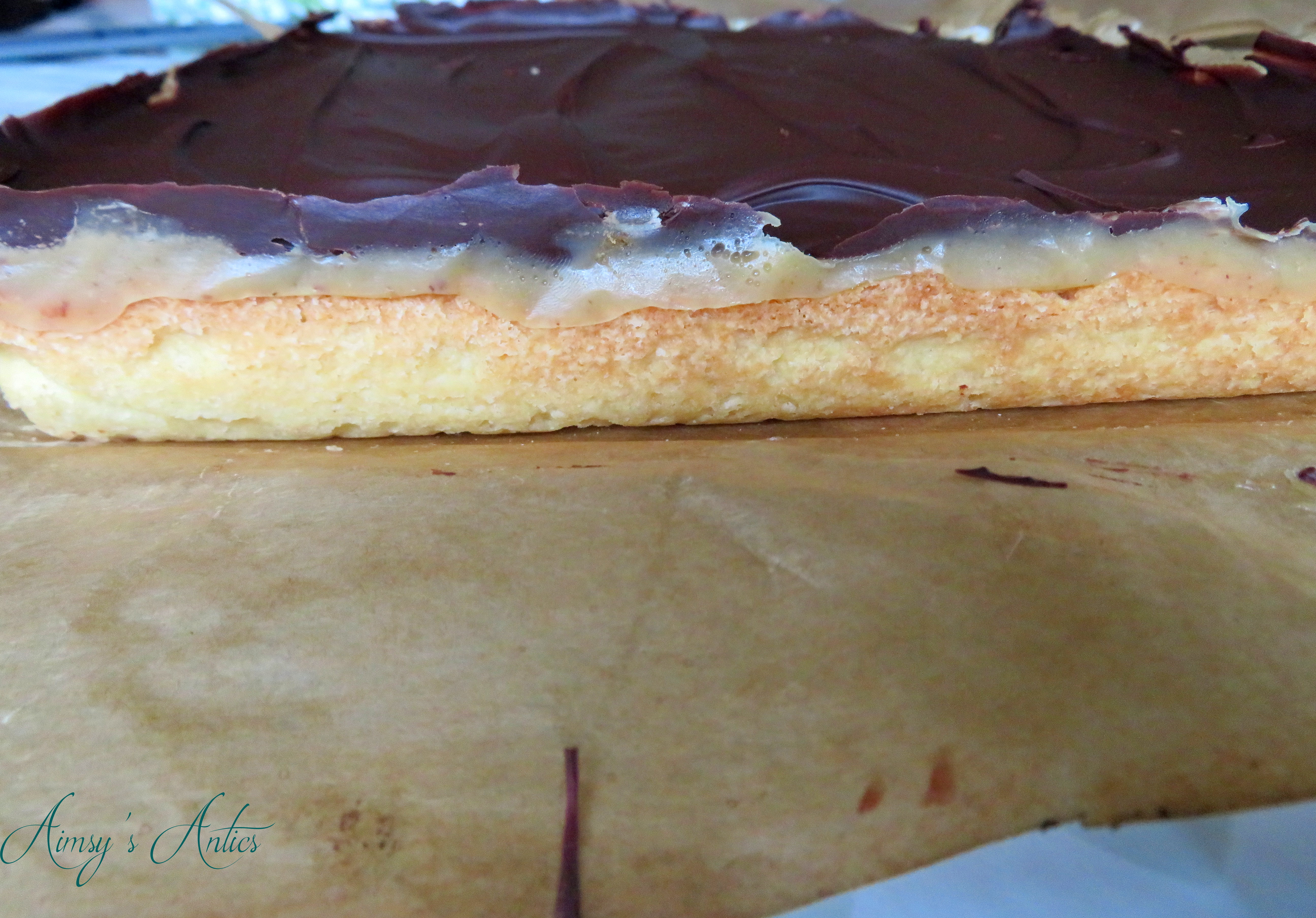 Caramel shortbread slab showing the three layers of shortbread, caramel and chocolate.