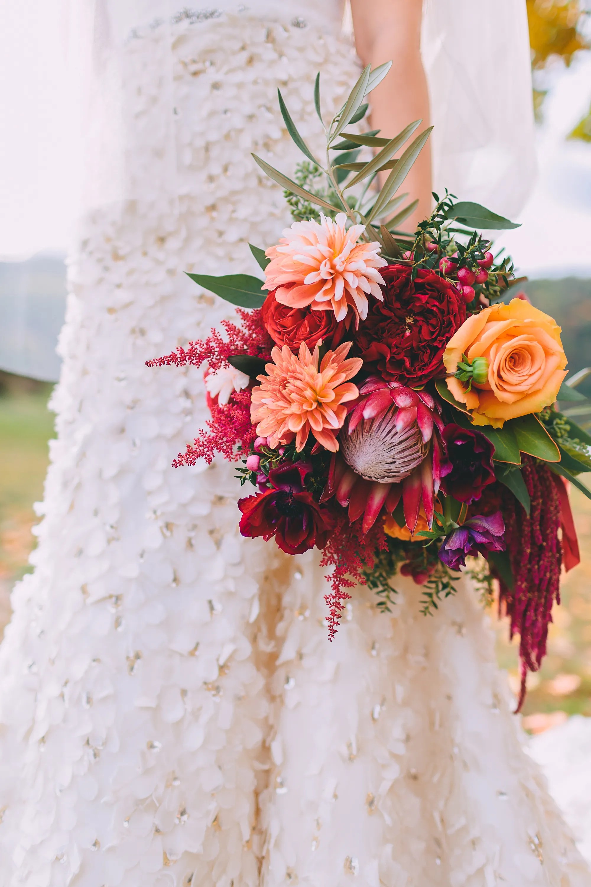 Find the perfect venue for your wedding. Fall-Colored Protea, Rose, Astilbe, and Dahlia Bouquet