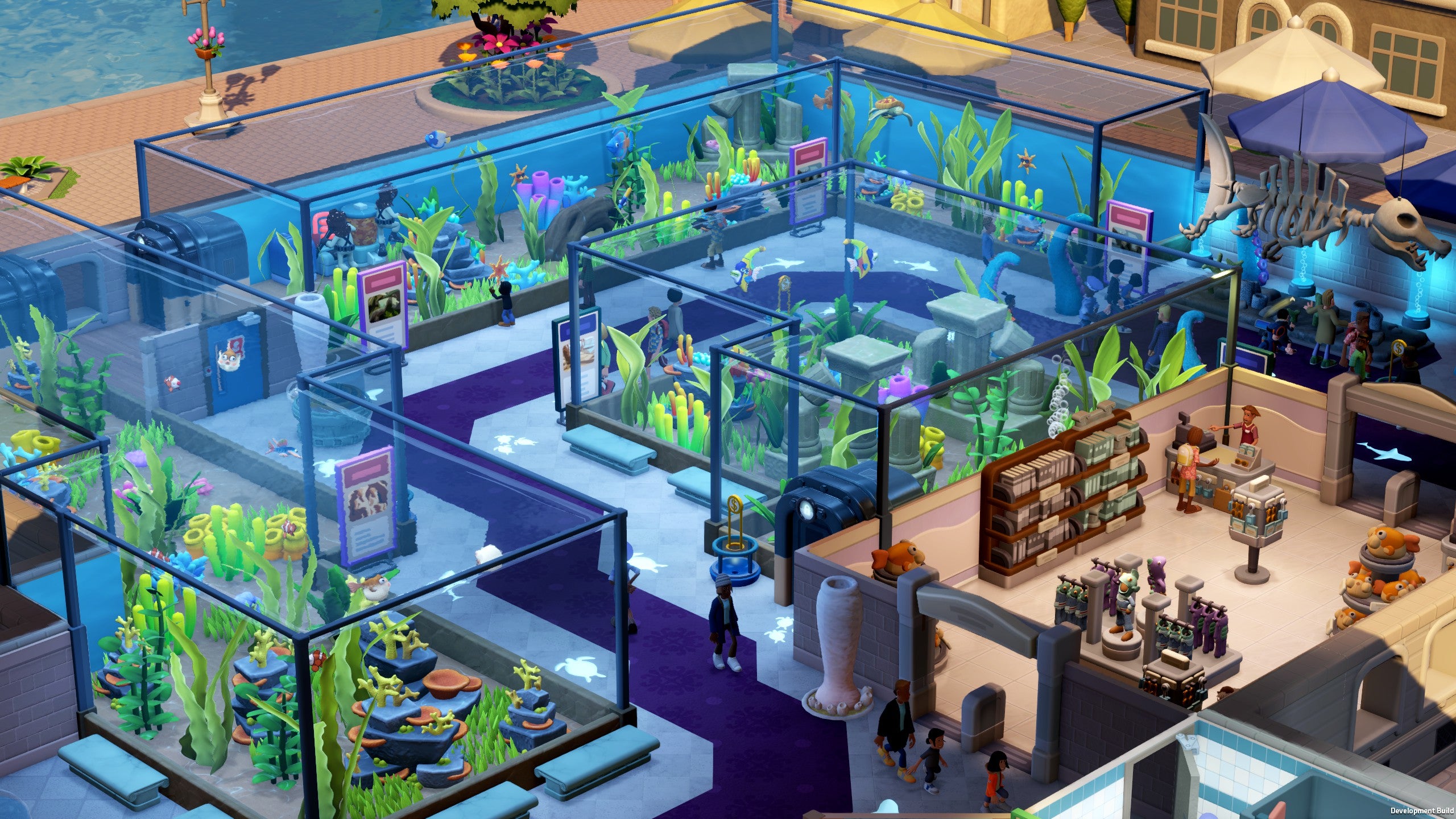 An overhead view of the Marine Life Museum in Two Point Museum, showing multiple tropical fish exhibits and the gift shop