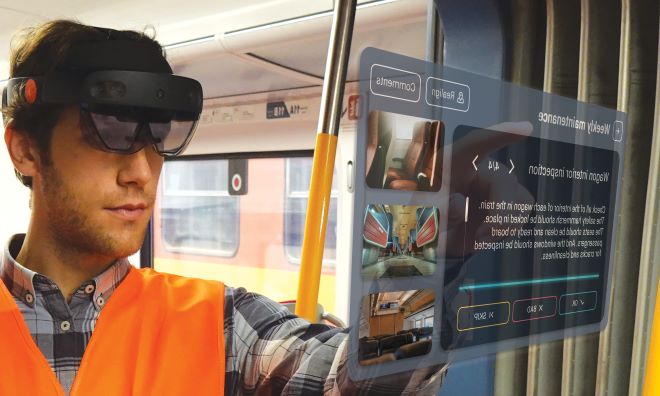 Mann mit AR-Brille HoloLens 2 auf dem Kopf in einem Bahnwaggon bedient ein digitales Inspektionspanel