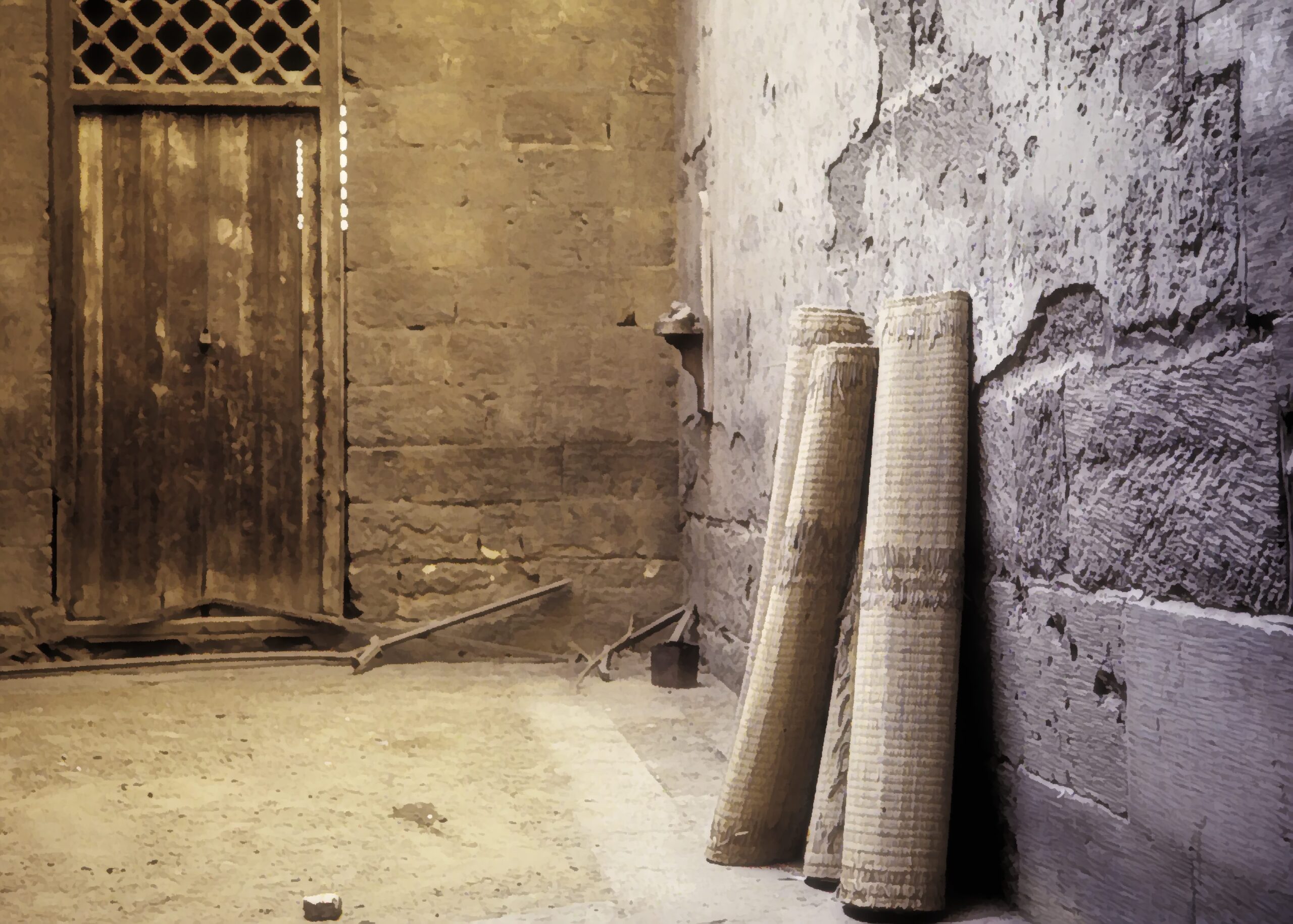 Some prayer mats leaning against a wall inside a mosque