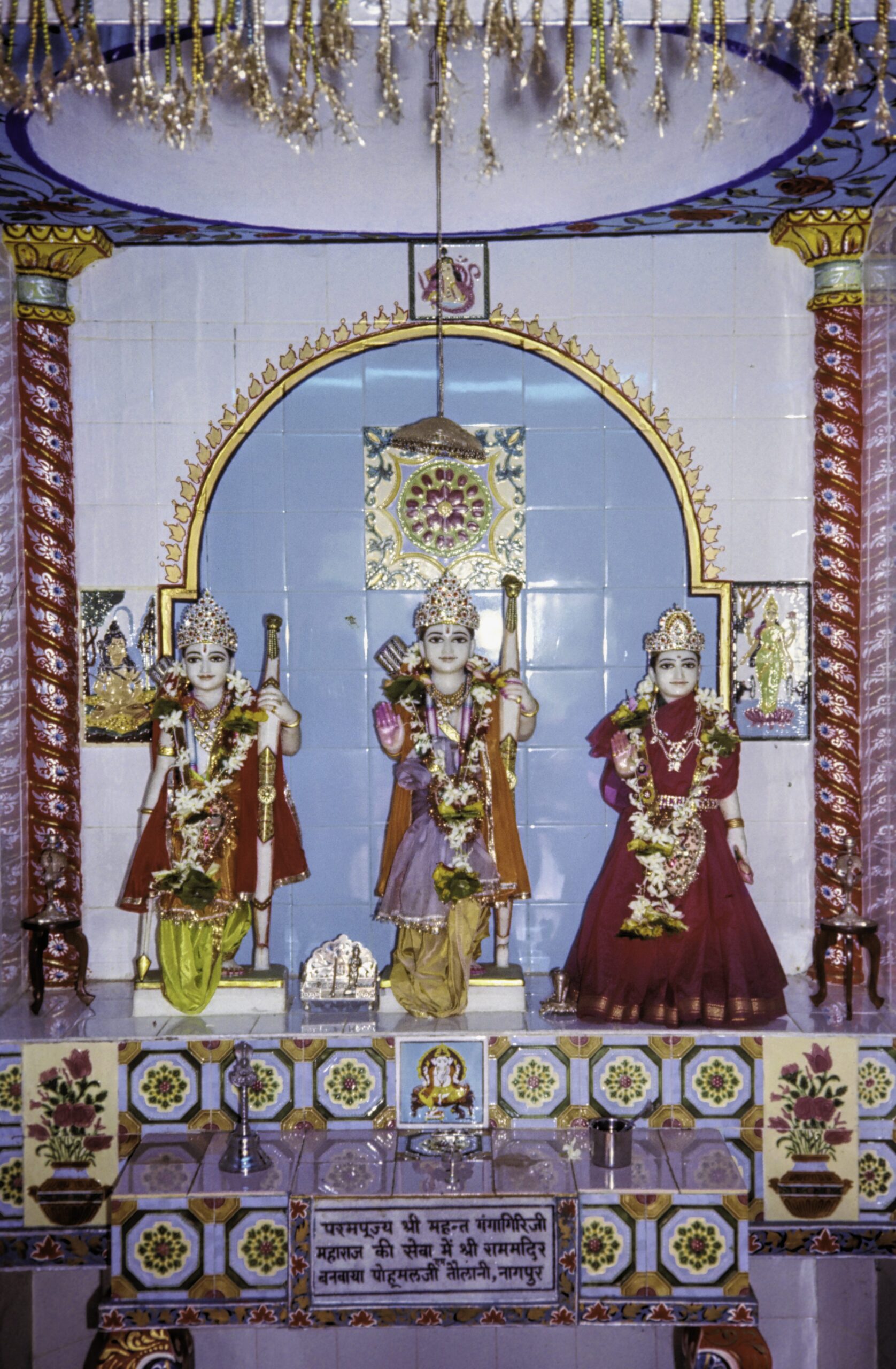 Three idols at a Hindu temple representing the trinity of Brahma, Vishnu, and Shiva