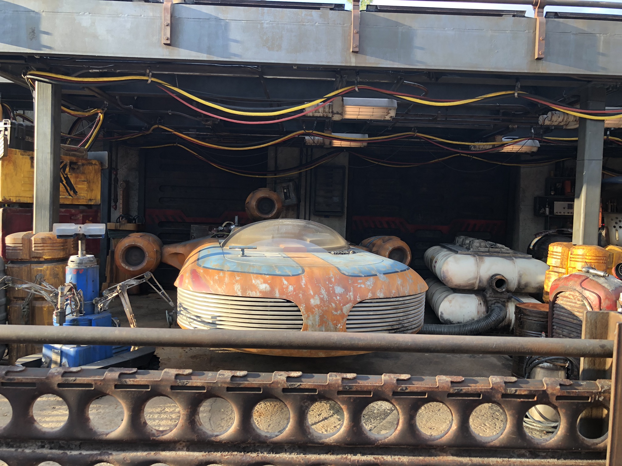 showing robot and old air ship in a open end garage