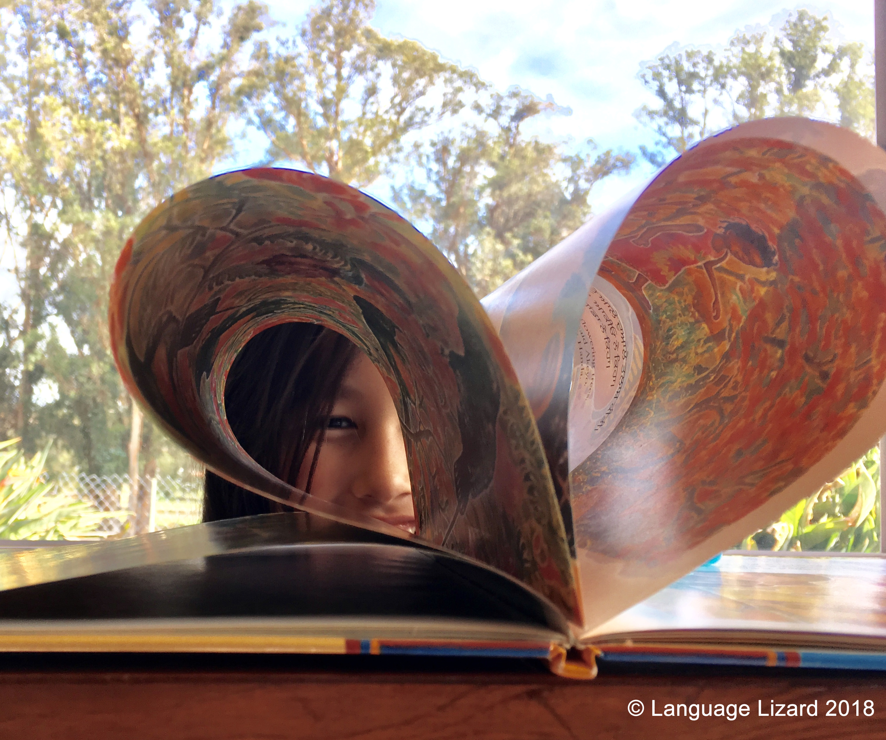 Child looking through the pages of a book