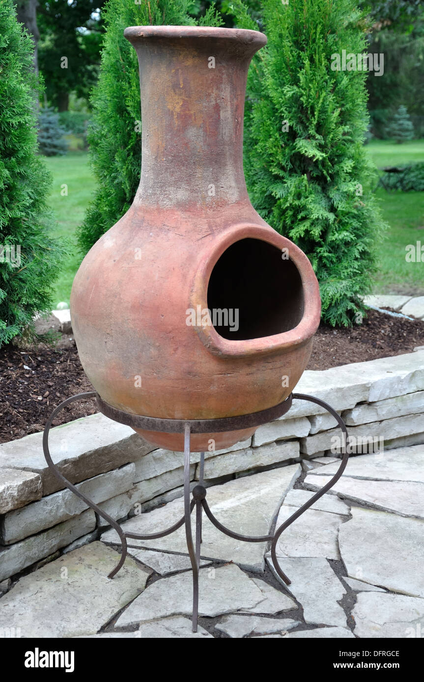 There are few things more welcoming in an outdoor space than a fire pit. chiminea on iron stand Stock Photo: 61368734 - Alamy