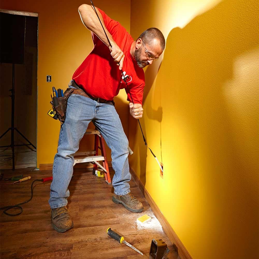 Attach the wire or cable to a fish tape or coat hanger using electrical tape, . Fishing Electrical Wire Through Walls | The Family Handyman