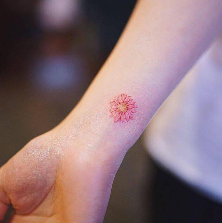 Red Daisy Tattoo On The Right Wrist. 720_x_719_jpg