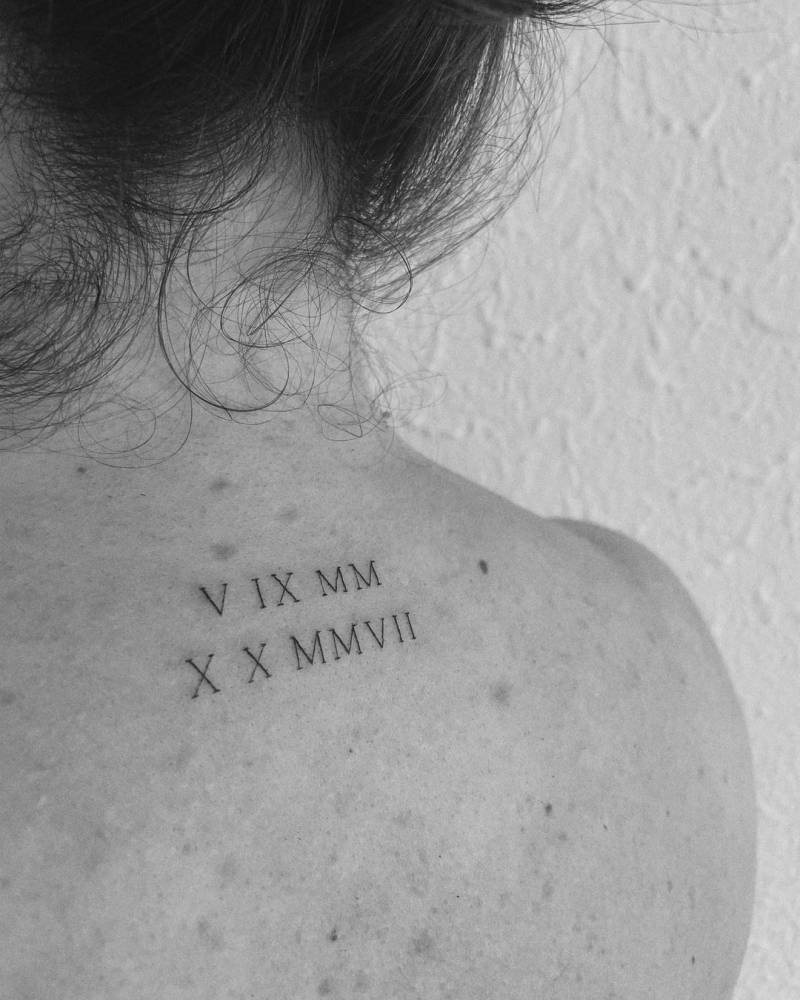 Roman Numerals Tattoo On The Upper Back. 1000_x_800_jpg
