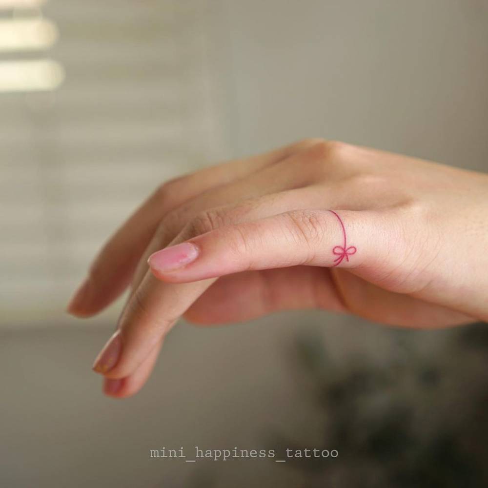 Fine Line Ribbon Ring Tattoo On The Finger. 1000_x_1000_jpg