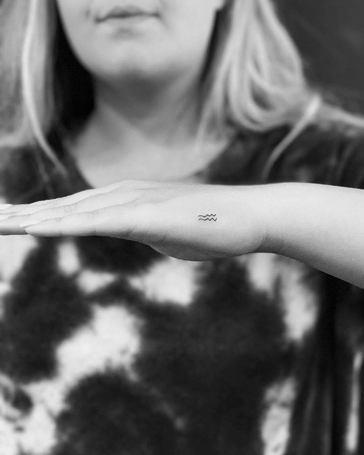 Aquarius Zodiac Symbol Tattoo On The Left Hand. 937_x_750_jpg