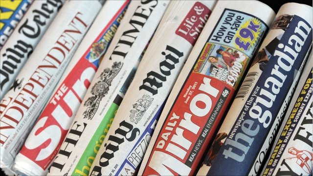 rolled up front covers of newspapers