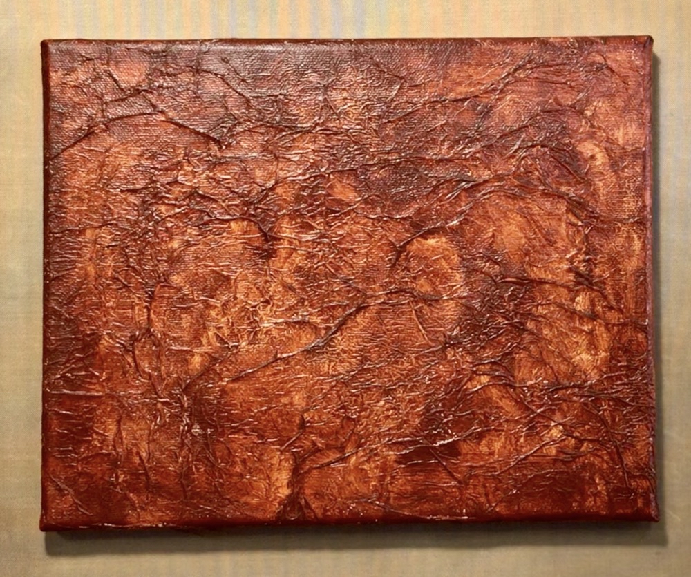 Photo of the front of the canvas after applying the tissue paper and painting it with Liquitex Basics Burnt Sienna.