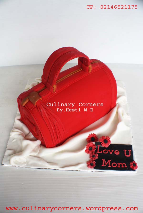 Shown in fondant finish with fondant accessories. Gucci Handbag Cake Culinary Corners