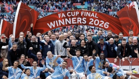 Man City players lifting the FA Cup