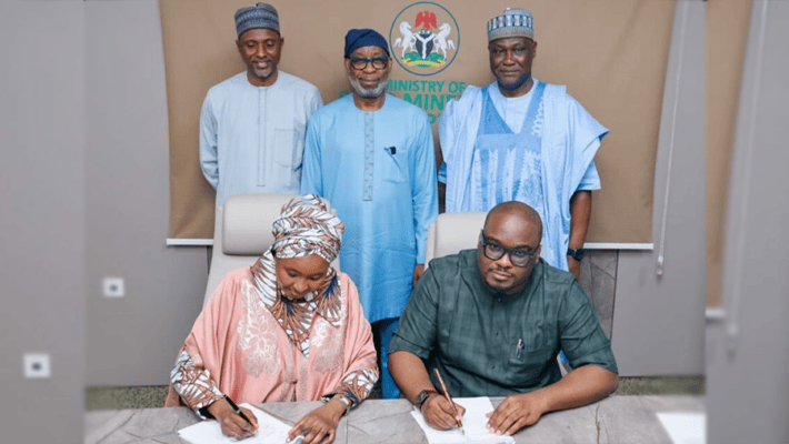 The Executive Secretary of the Solid Minerals Development Fund, Hajiya Fatima Shinkafi (left) and Franklin Edochie, the Deputy Director of the Africa Finance Corporation and Head, Metals and Mining signing an investment