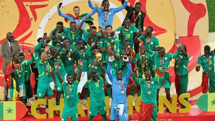 Sadio Mane with trophy being hoisted by teammates