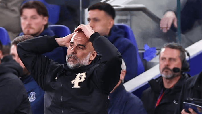 Pep Guardiola holding his head