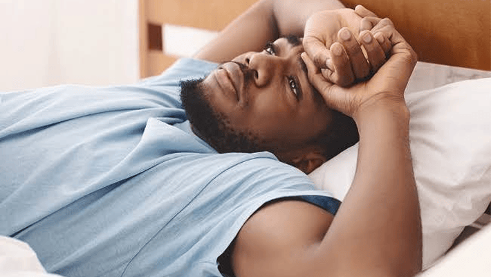 An individual on bed unable to sleep