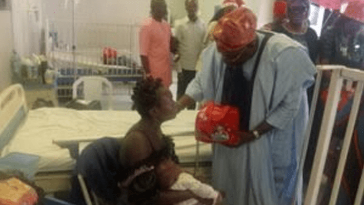 Dr Adeshola Pitan presenting gifts to patients at the Children’s Ward of Alimosho General Hospital during the Christmas celebration
