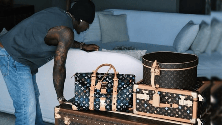 Asake and his Louis Vuitton trunk