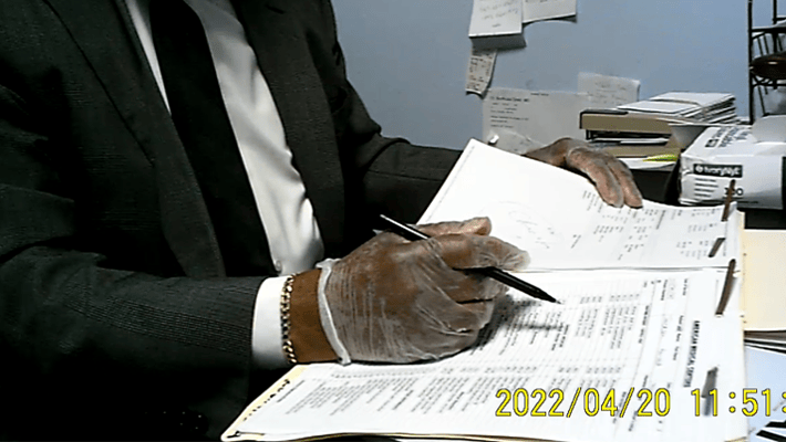 Brown-Arkah in an undercover recording meeting with a confidential source posing as a patient holding a pen over the patient’s billing sheet.