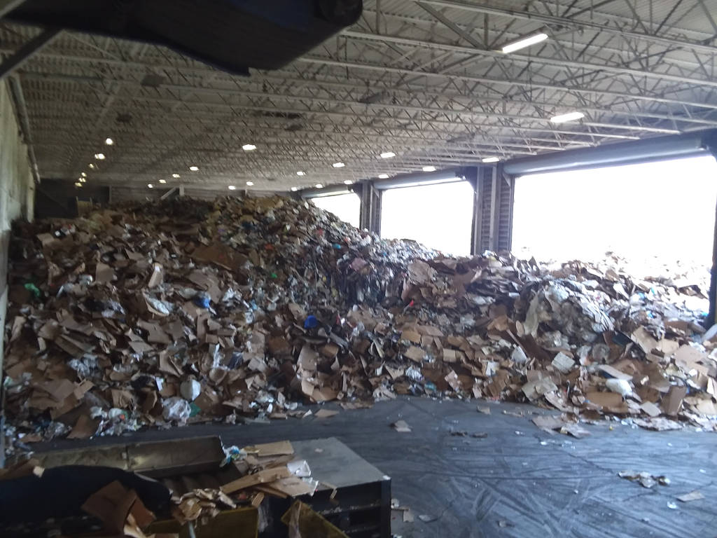 Recyclables on the tipping floor at the Materials Recovery Facility