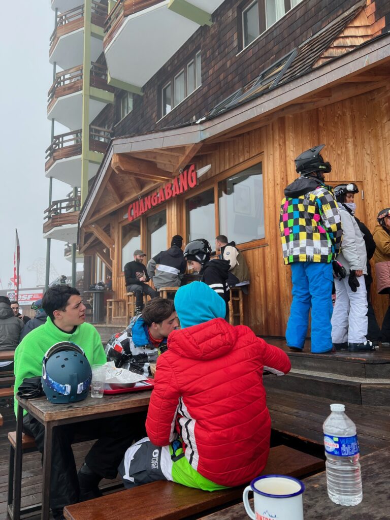 People in their ski and snowbaording gear crowding outside Changabangs waiting to place their food orders