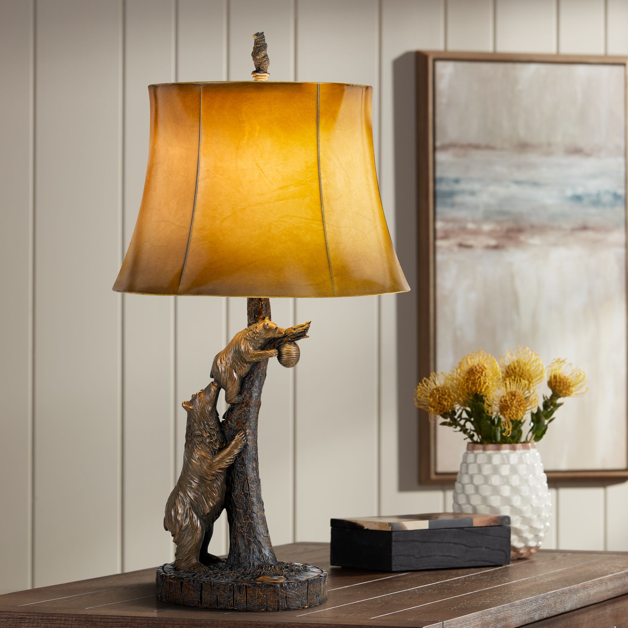 • featuring a matte black finish with center detailing for a cool and contemporary look. bear antique bronze table lamp with leatherette shade