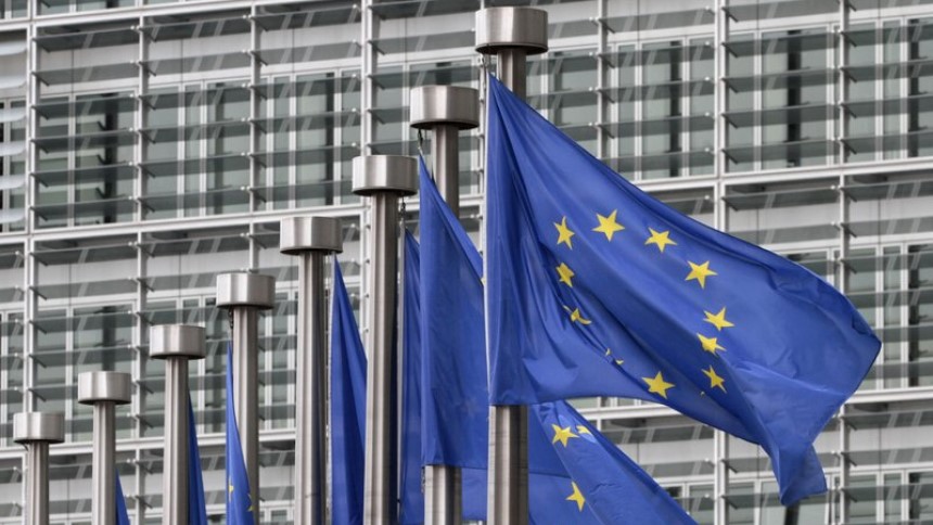FILE - In this May 9, 2011 file photo, EU flags fly outside the European Commission headquarters in Brussels. 
