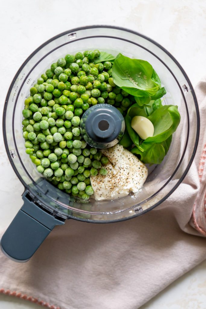 pea pesto ingredients in a food processor