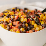 black bean and corn dip in a white bowl