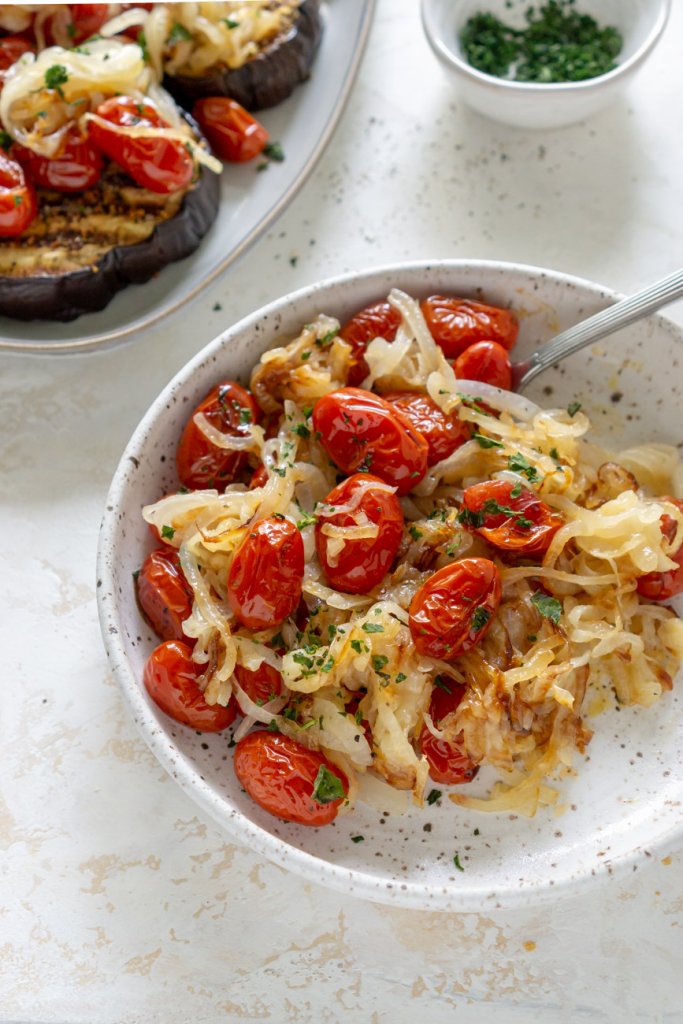 tomatoes and onions on a white plate