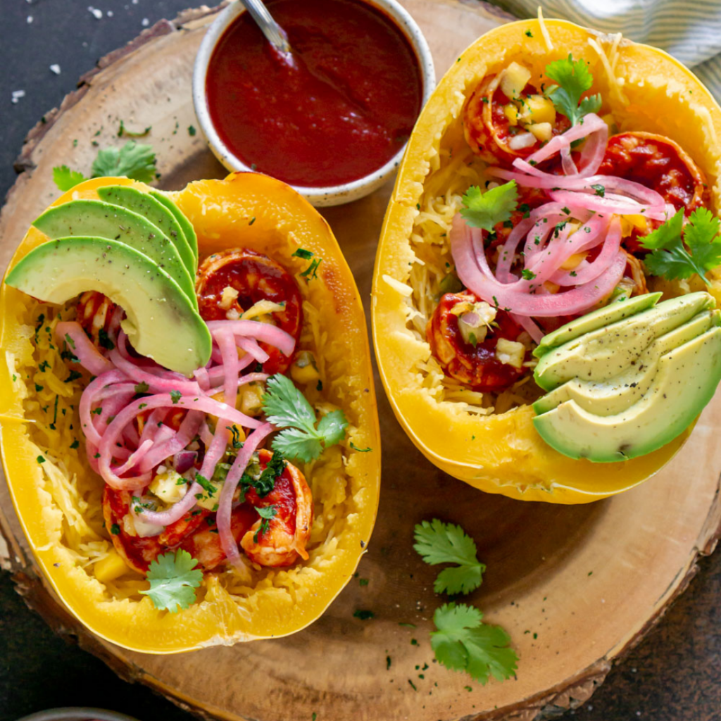 BBQ shrimp spaghetti squash boats on a wood tray