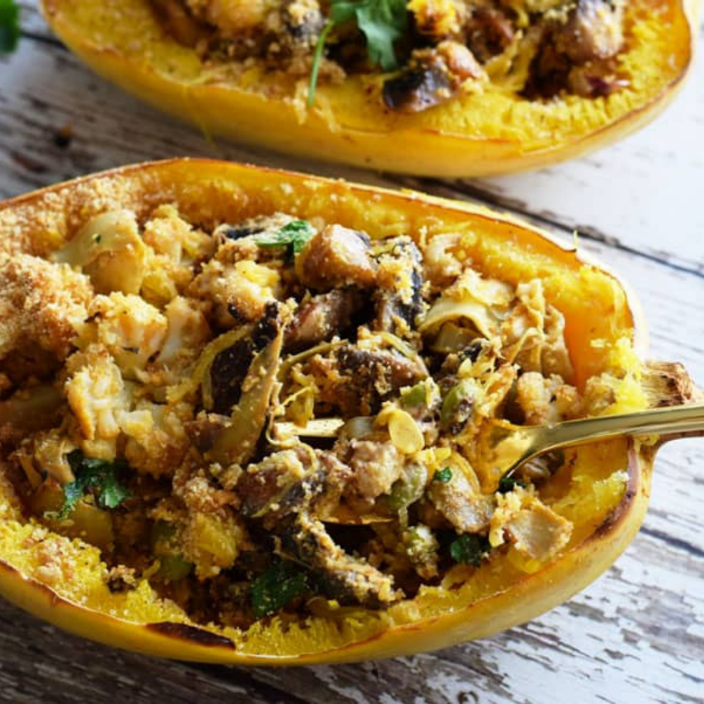 spaghetti squash casserole boats on a wood surface