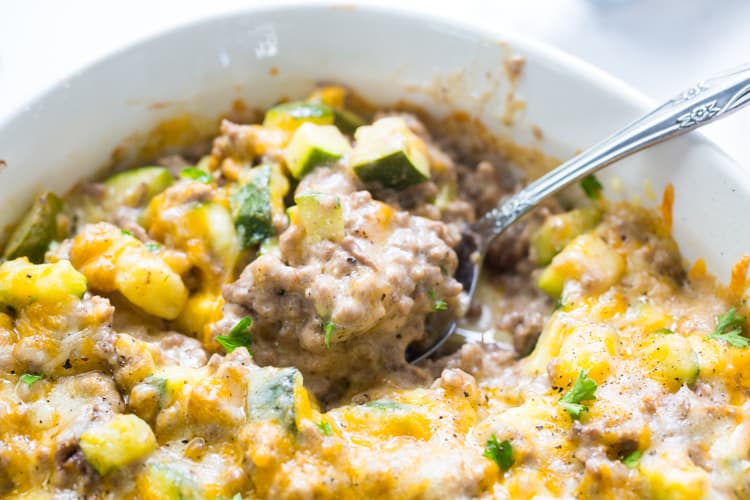 Keto Zucchini with Ground Beef in a casserole dish with a spoon.