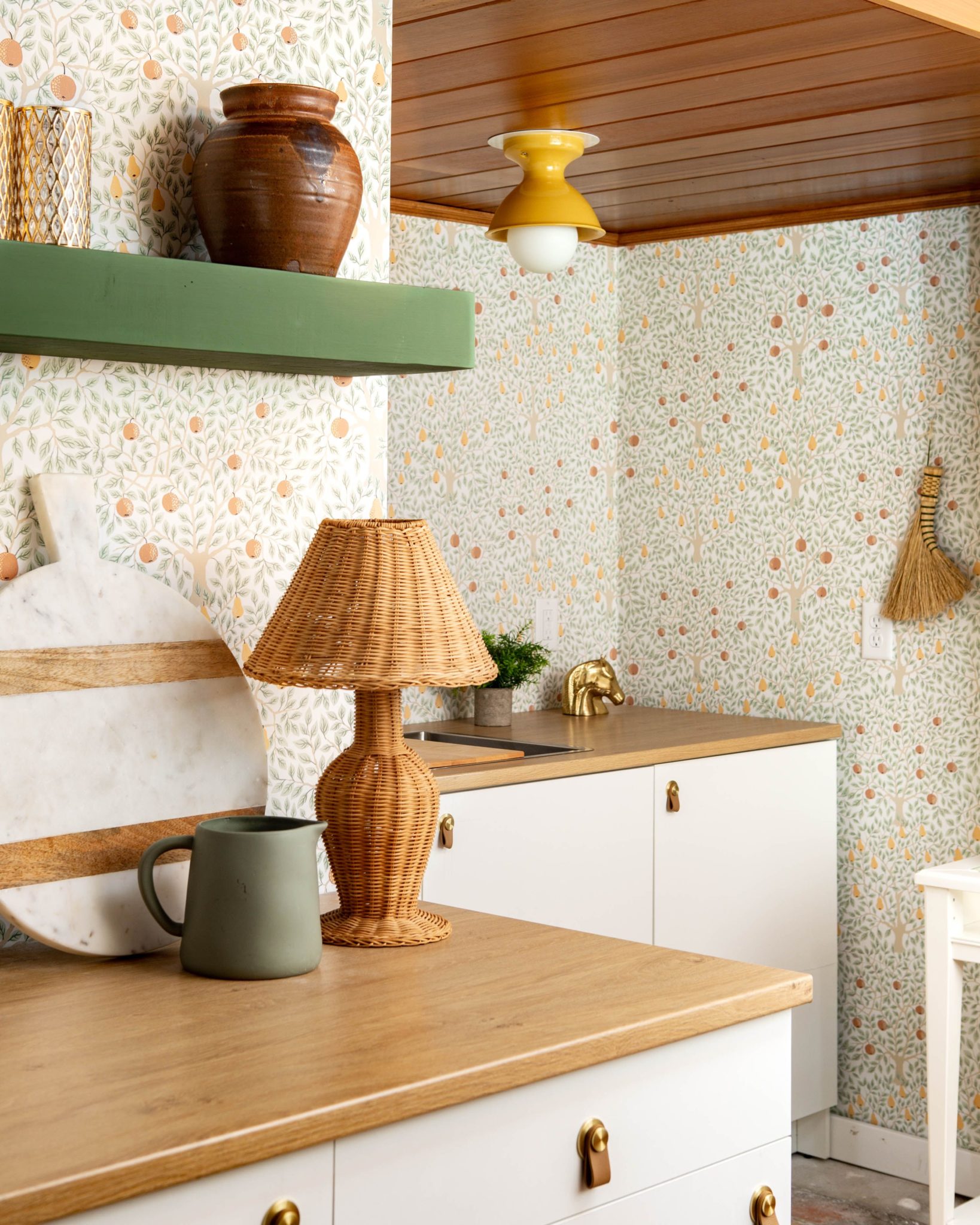 The lesser kitchen with white cabinets, countertops in brown, green, and fruit fruits