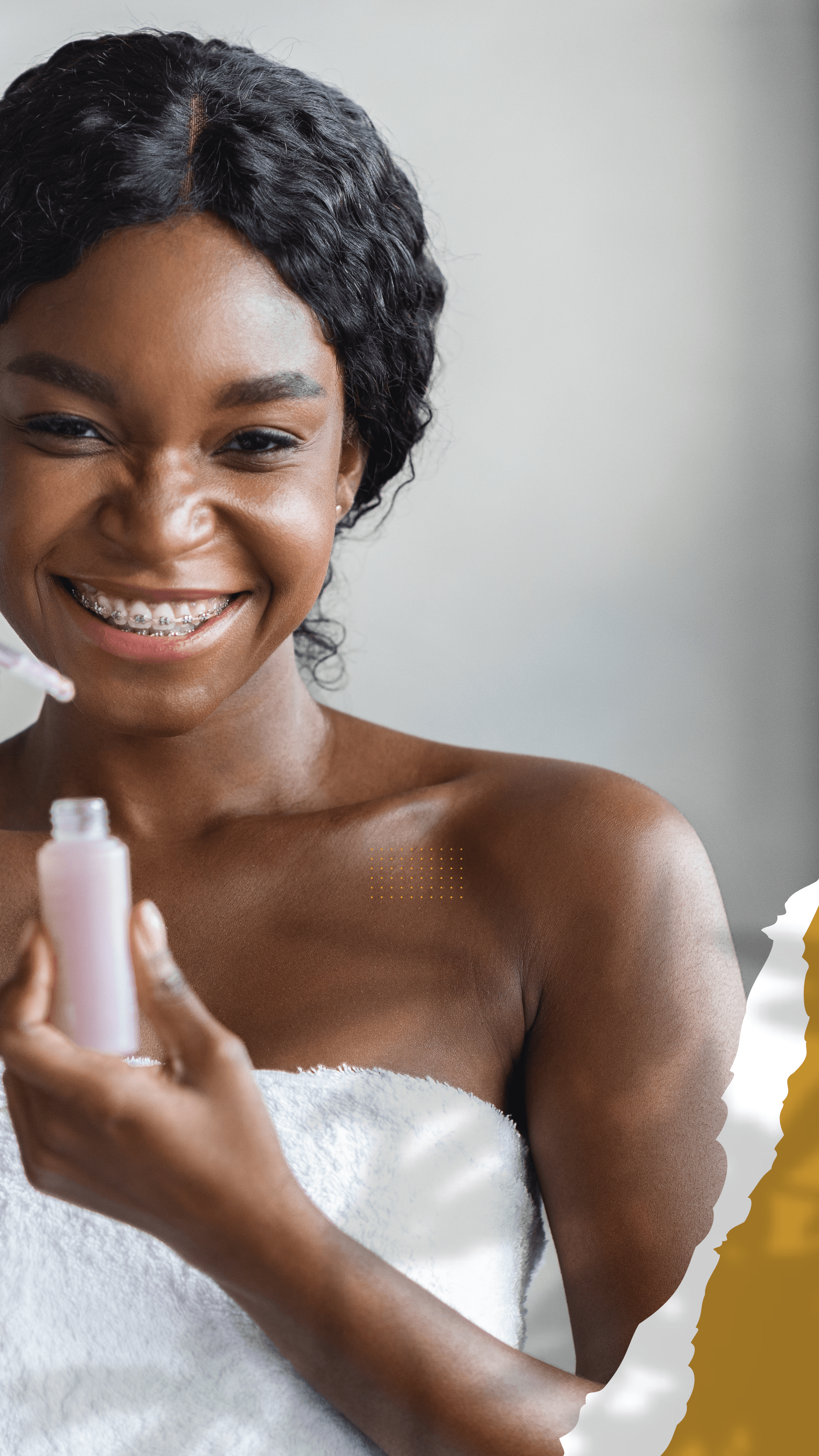 Girl with dark hair and bracers smiling as she gets ready for her Spa services.