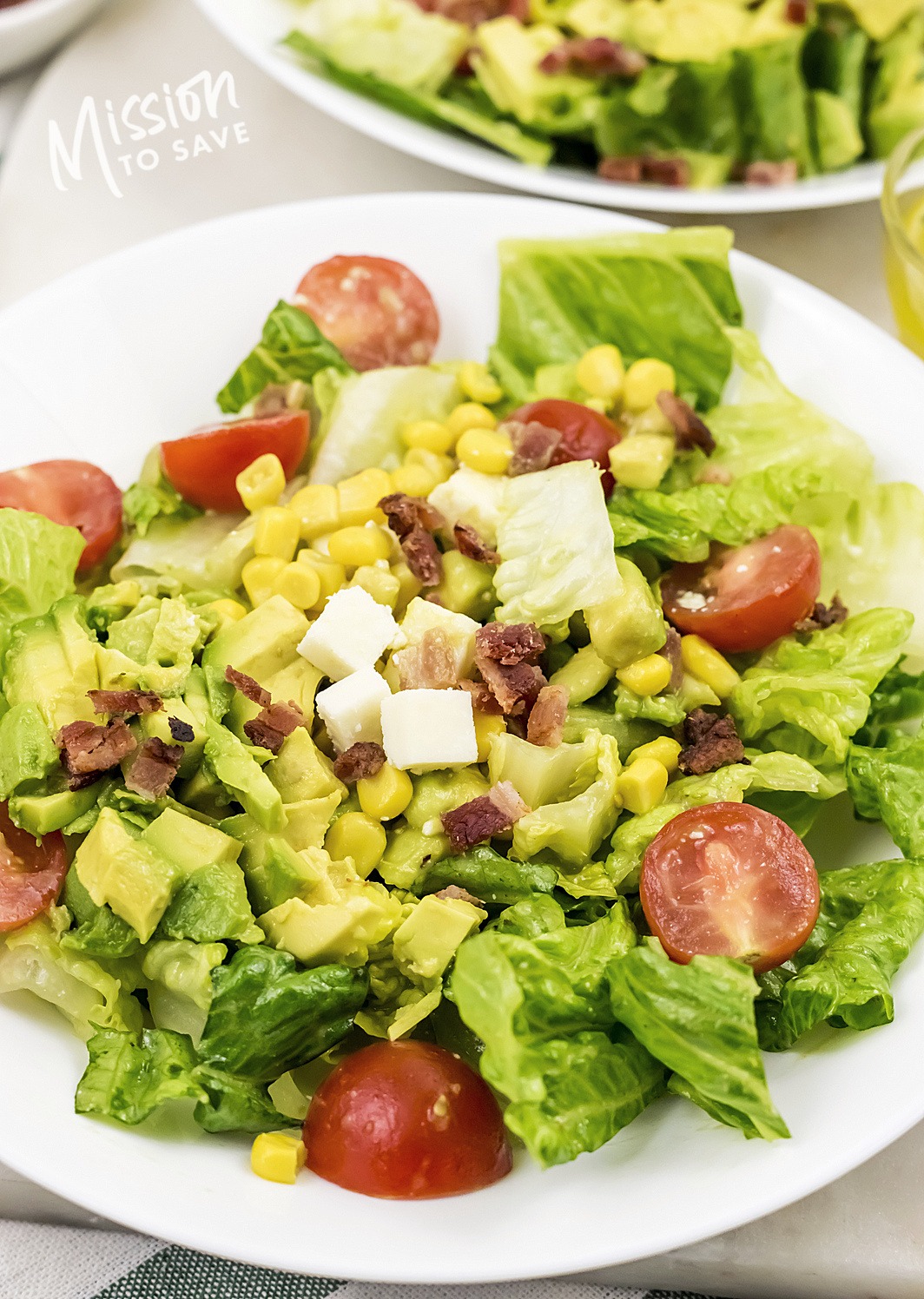 close up of cobb salad with avocado bacon corn