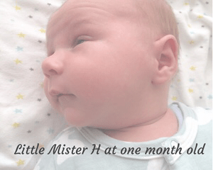http://mrshsfavouritethings-com.stackstaging.com A faded photograph of a one month old baby boy wearing a Bamboo Bunny Romper from Bambini & Me and lying on a white blanket covered in tiny yellow, green and grey stars_ with the title "Little Mister H at one month old" - Mrs H's favourite things