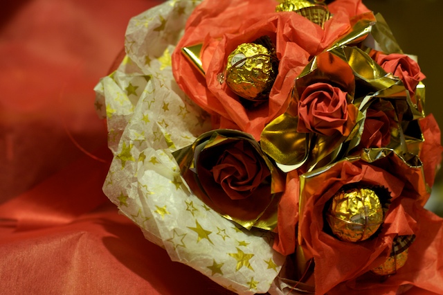 If the idea of a dozen red roses arranged in a bland but tasteful glass vase and accompanied by a sprig of baby’s breath doesn’t quite do it for you, good news: Ferrero Rocher Origami Rose Bouquet Promises Weddings By Natalie Kam