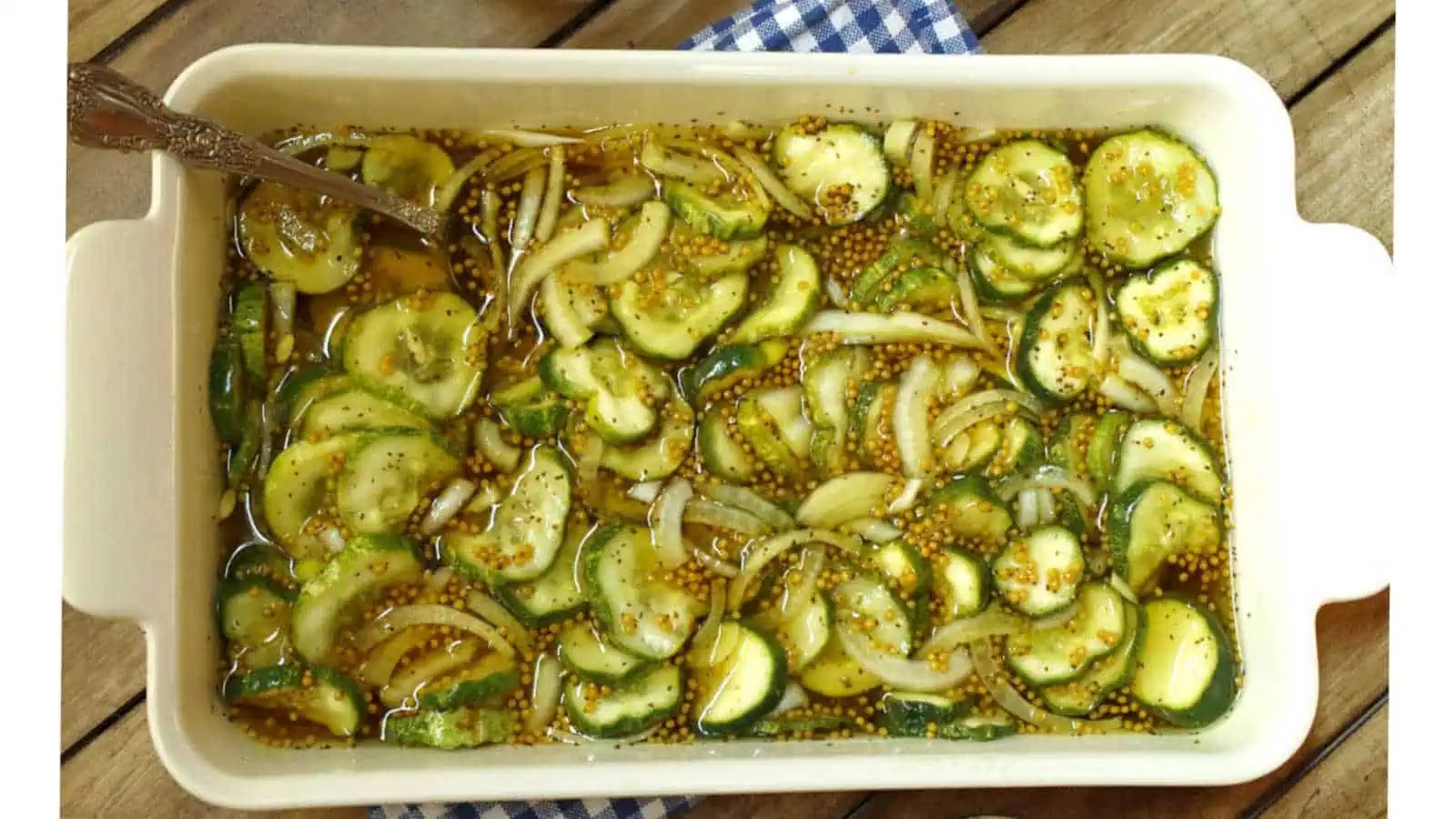 Sliced cucumbers and onions marinating in a seasoned vinegar sauce.