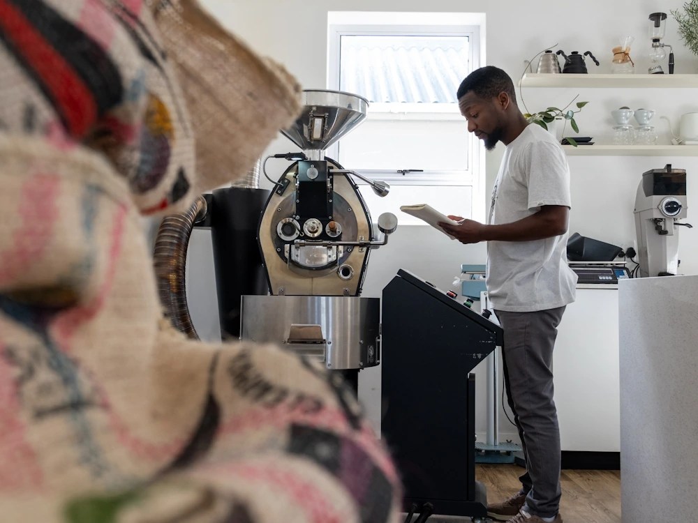 - Healthy Brew Hub A man uses small roaster.