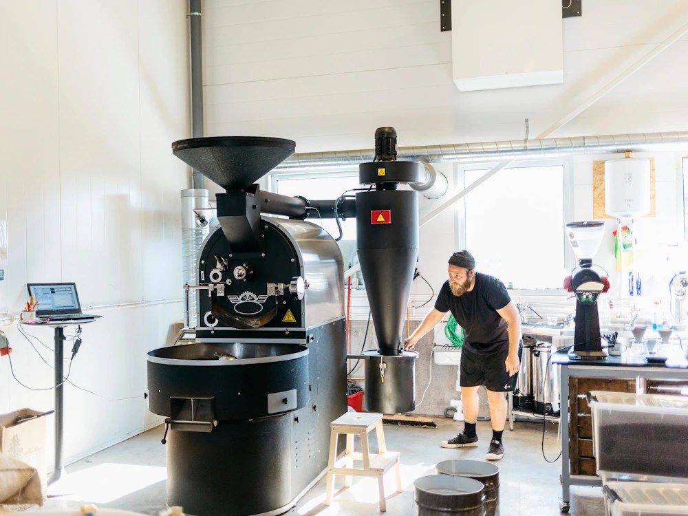 - Healthy Brew Hub Man working in a roastery.