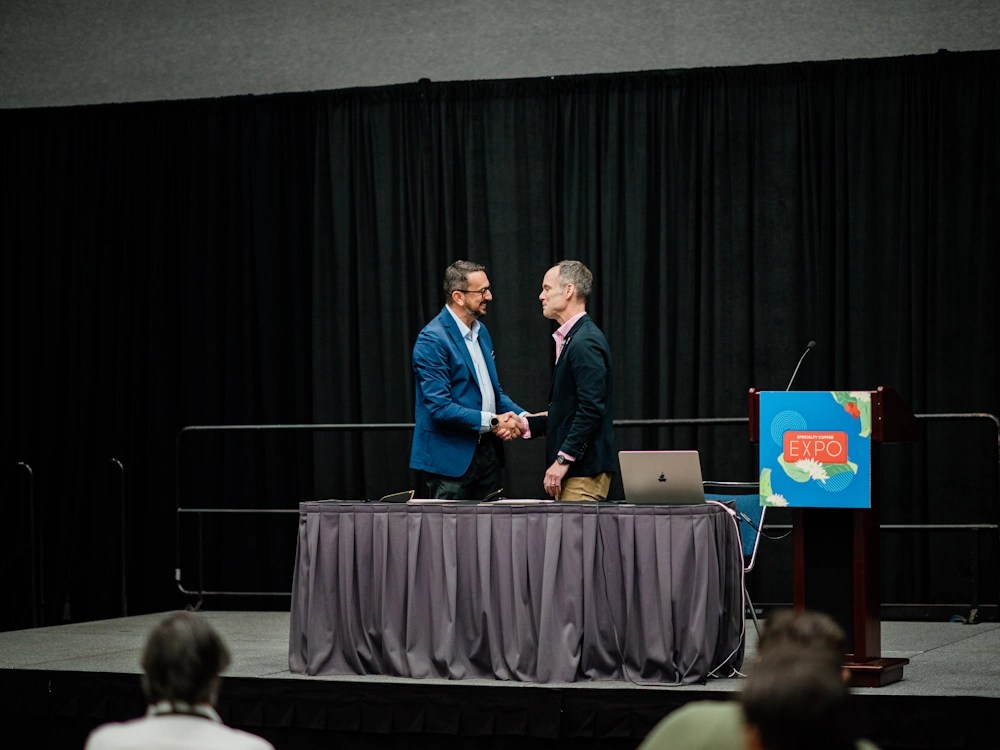 - Healthy Brew Hub Michael Sheridan of CQI and Yannis Apostolopoulos of the SCA at Specialty Coffee Expo in Houston.