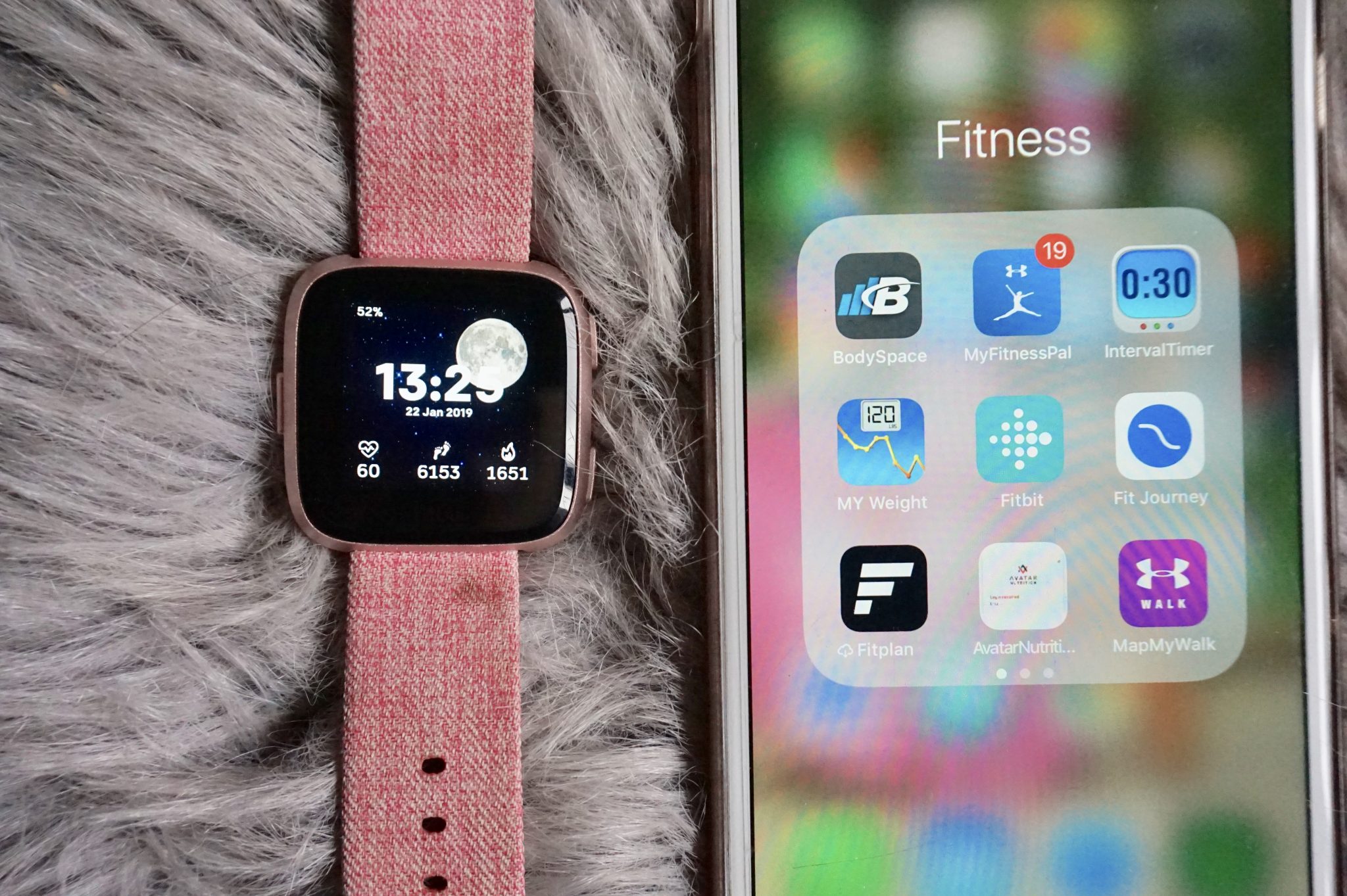 Fitbit Versa & Iphone display showing 9 fitness apps 