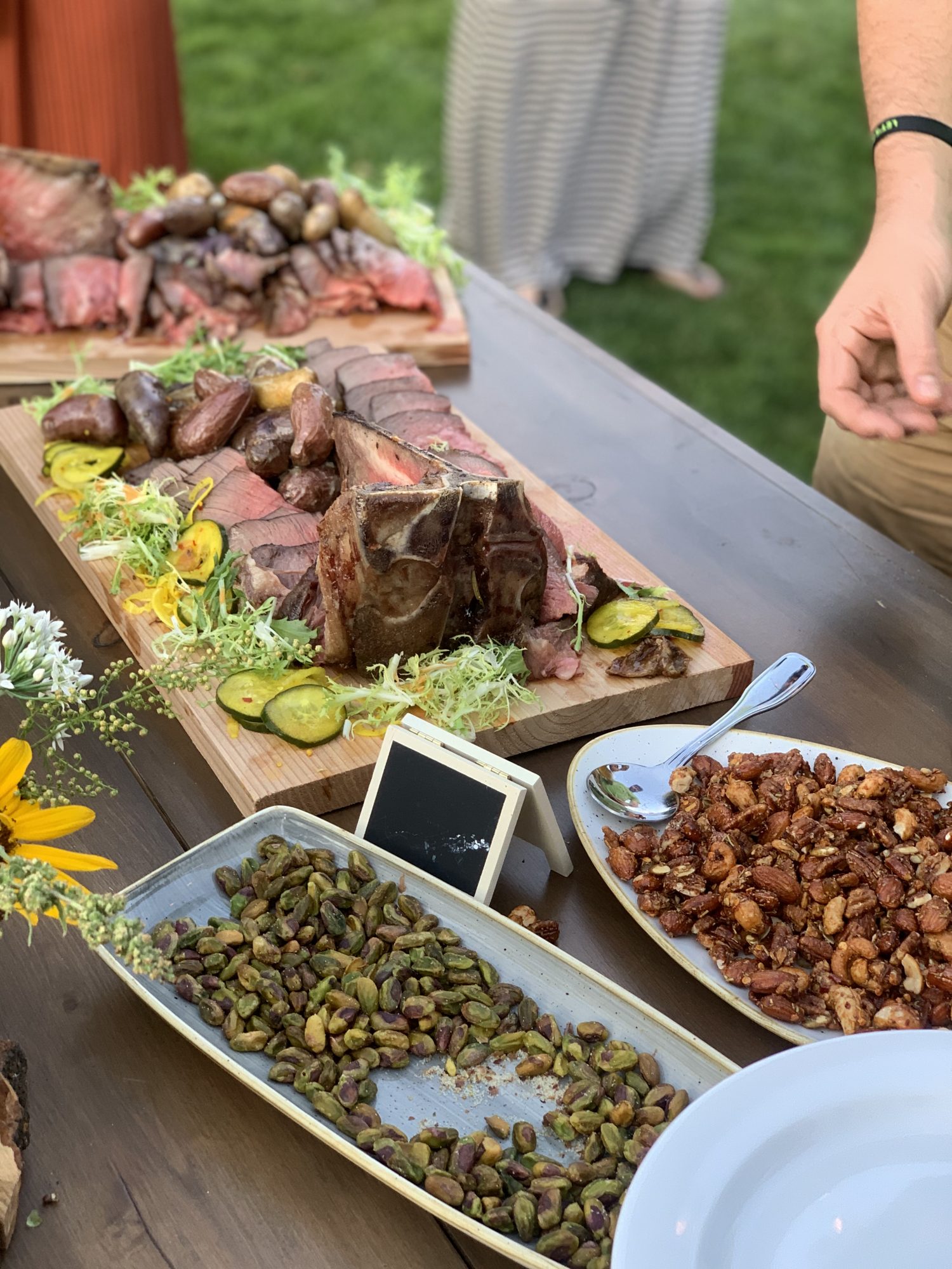 Plate of reverse seared Porterhouse steak, fingerling potatoes, pickled pickles , seasoned nuts. #hopsharvestfarmdinner For more food and travel posts be sure to follow me at www.sprouting-vitality.com or on instagram at sproutingvitality. #kenzinthekitch or #mckenzieonthemove