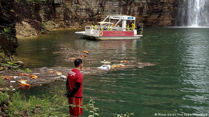 The photograph, taken in pedra do telegrafo, brazil, show daredevil luis fernando candela, hanging from a cliff face with spectacular views . Brazil Several Dead As Cliff Collapses On Boats News Dw 08 01 2022
