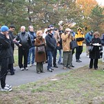 The crowd gathers around the bench