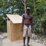 Eugene Joseph, building an Oxfam-supported latrine